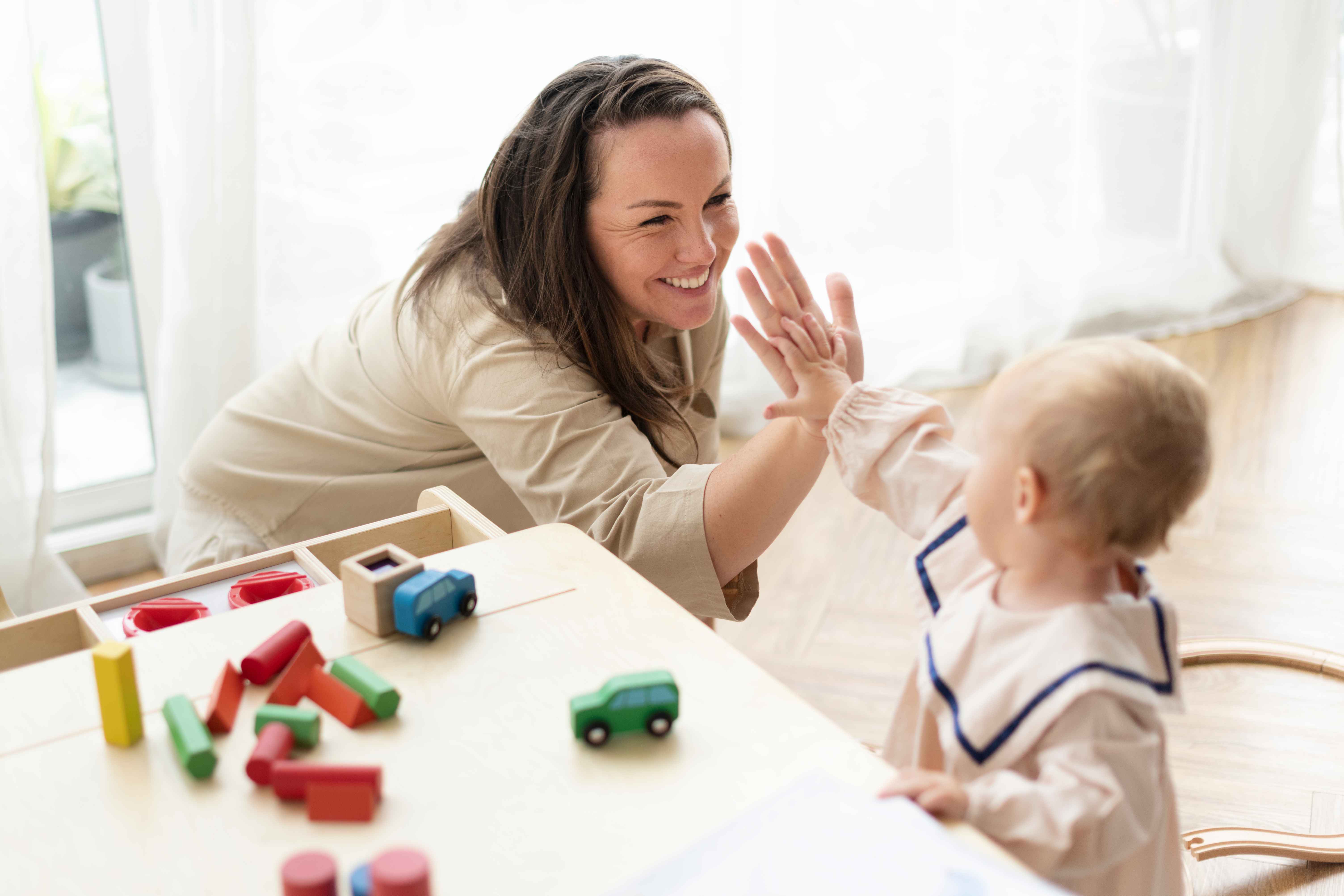 mother-baby-daughter-giving-high-fives_11zon